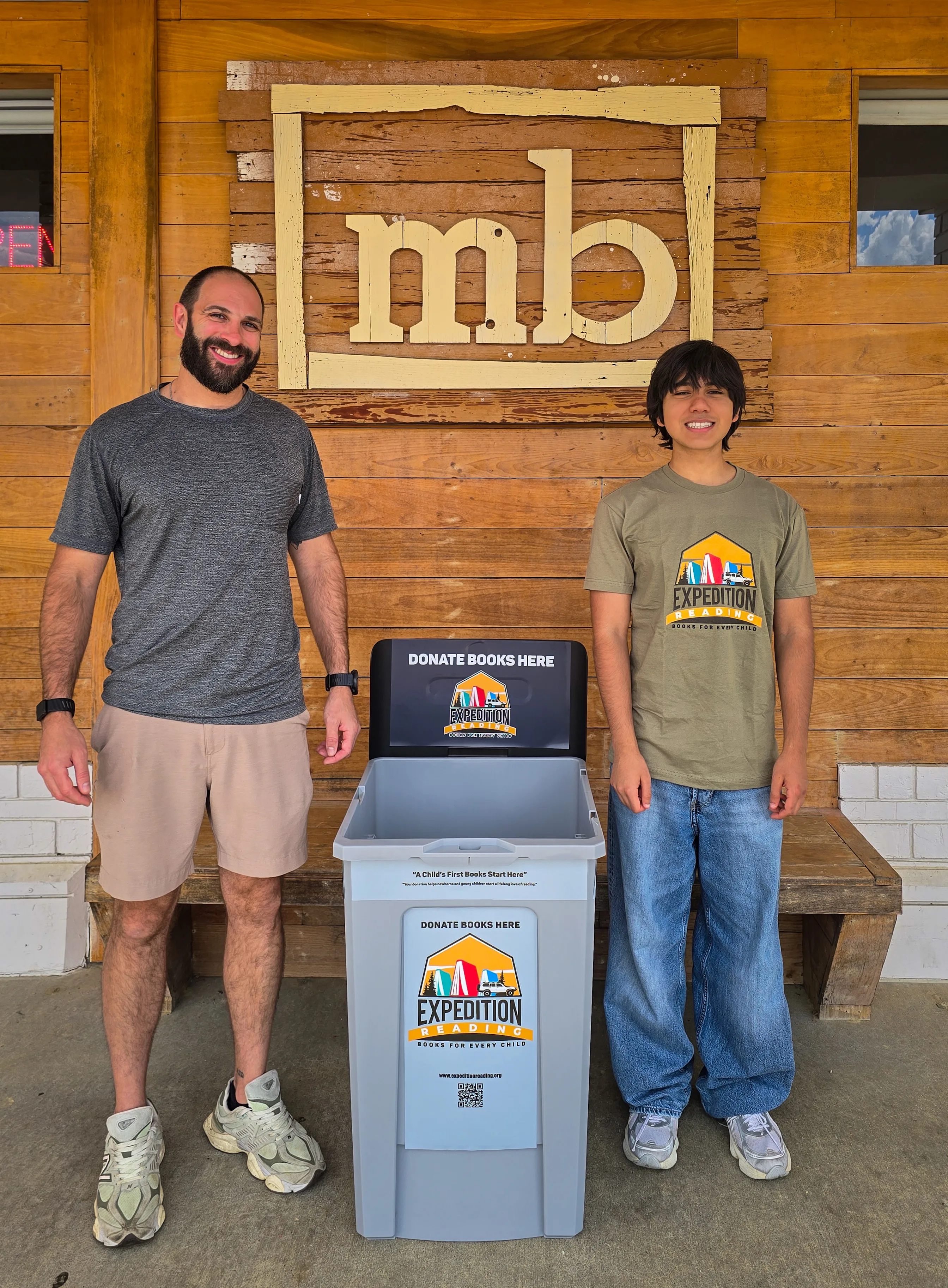 Expedition Reading handing off a donation bin at partner Moxie Burger